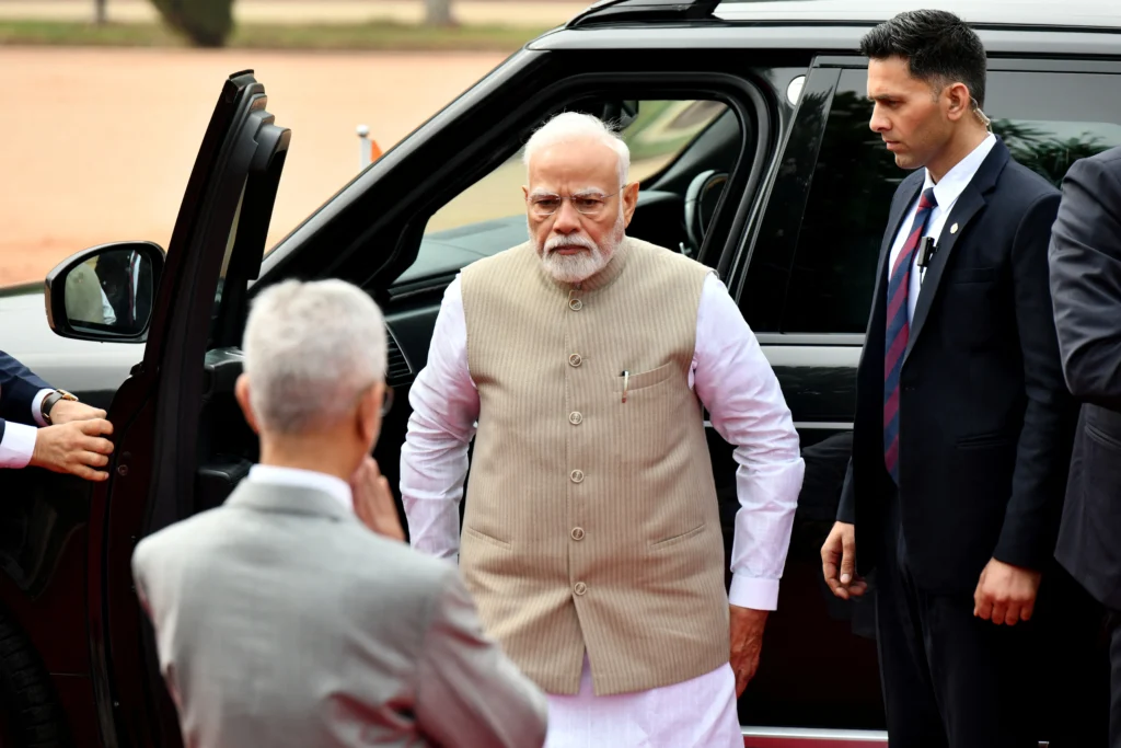 Indian Prime Minister arriving at an international summit venue with security personnel and officials